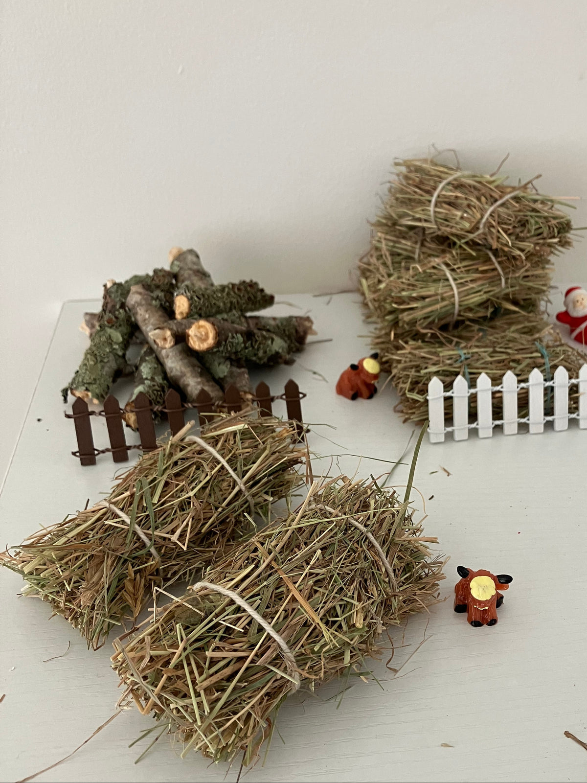 A miniature farm theme featuring jumbo hay bales (front) as well as the standard hay bales (with Santa resting on his journey).