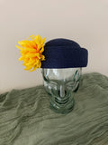 Ladies blue adjustable pillbox hat with bright yellow flowers